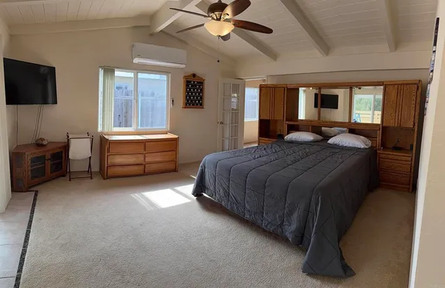 a bedroom with a bed and a chandelier