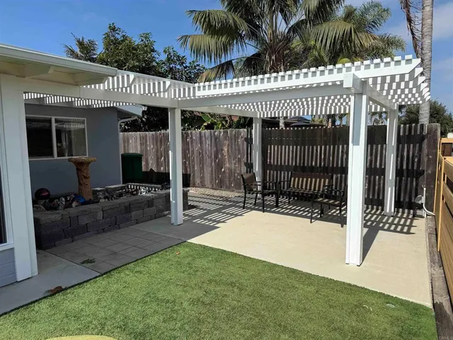 a view of a pathway of a house with wooden fence