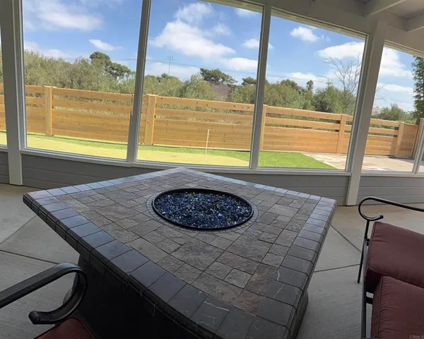 a living room with furniture and a floor to ceiling window