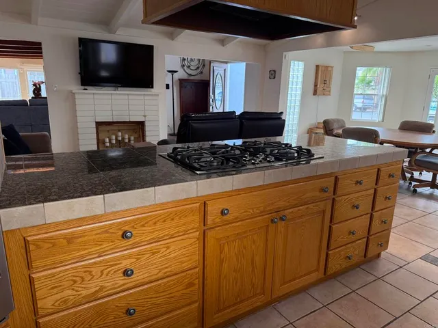 a kitchen with stainless steel appliances kitchen island granite countertop a stove and a sink