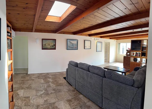 a living room with couches and next to a window