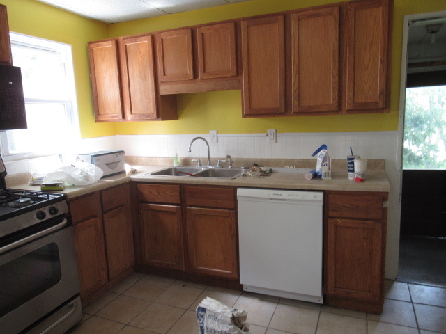 210 West Charles Street Champaign, IL 61820 - Photo 3 of 11 a kitchen with a sink dishwasher stove and cabinets