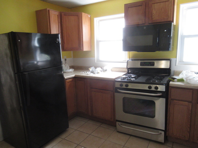 210 West Charles Street Champaign, IL 61820 - Photo 4 of 11 a kitchen with a refrigerator stove and microwave