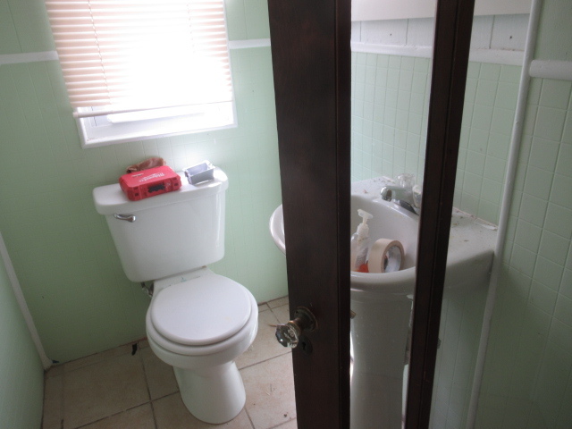 210 West Charles Street Champaign, IL 61820 - Photo 5 of 11 a white toilet sitting next to a bathroom sink