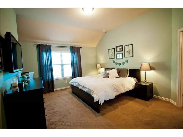 a bedroom with a bed and a lamp