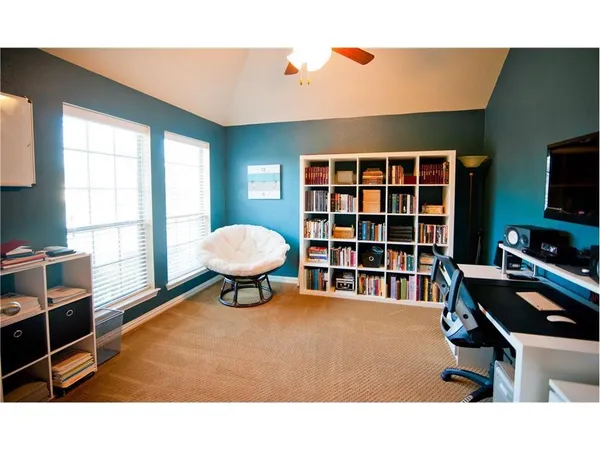 a livingroom with workspace and a window