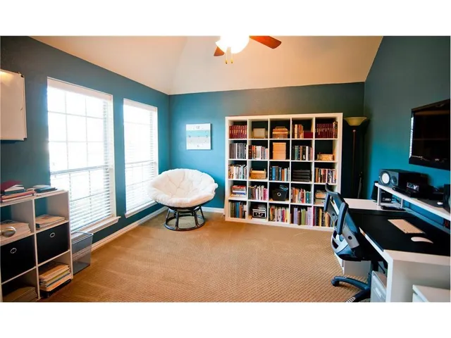 a livingroom with workspace and a window