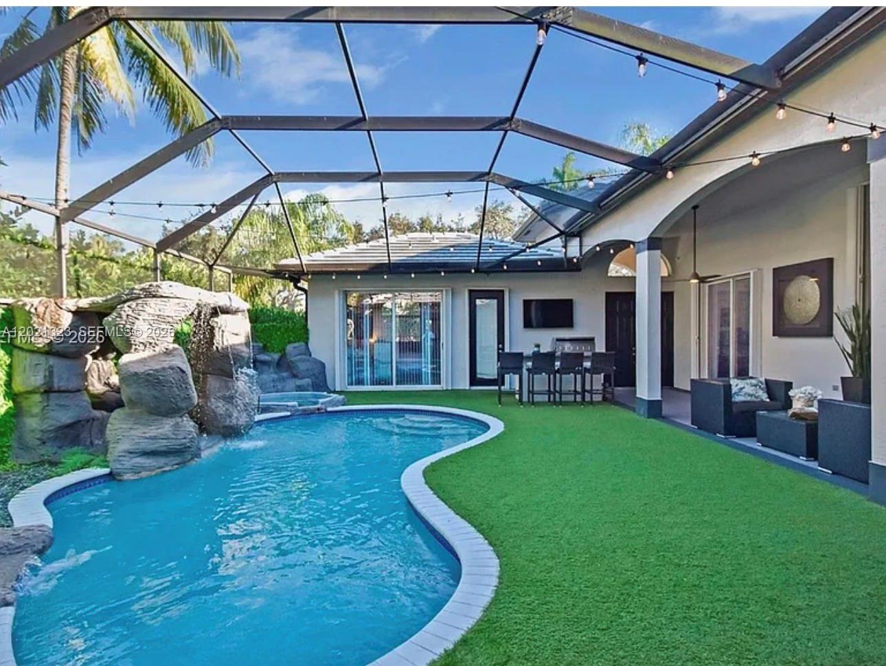 354 Mallard Road, Unit O Weston, FL 33327 - Photo 23 of 29 a view of a backyard with table and chairs under an umbrella