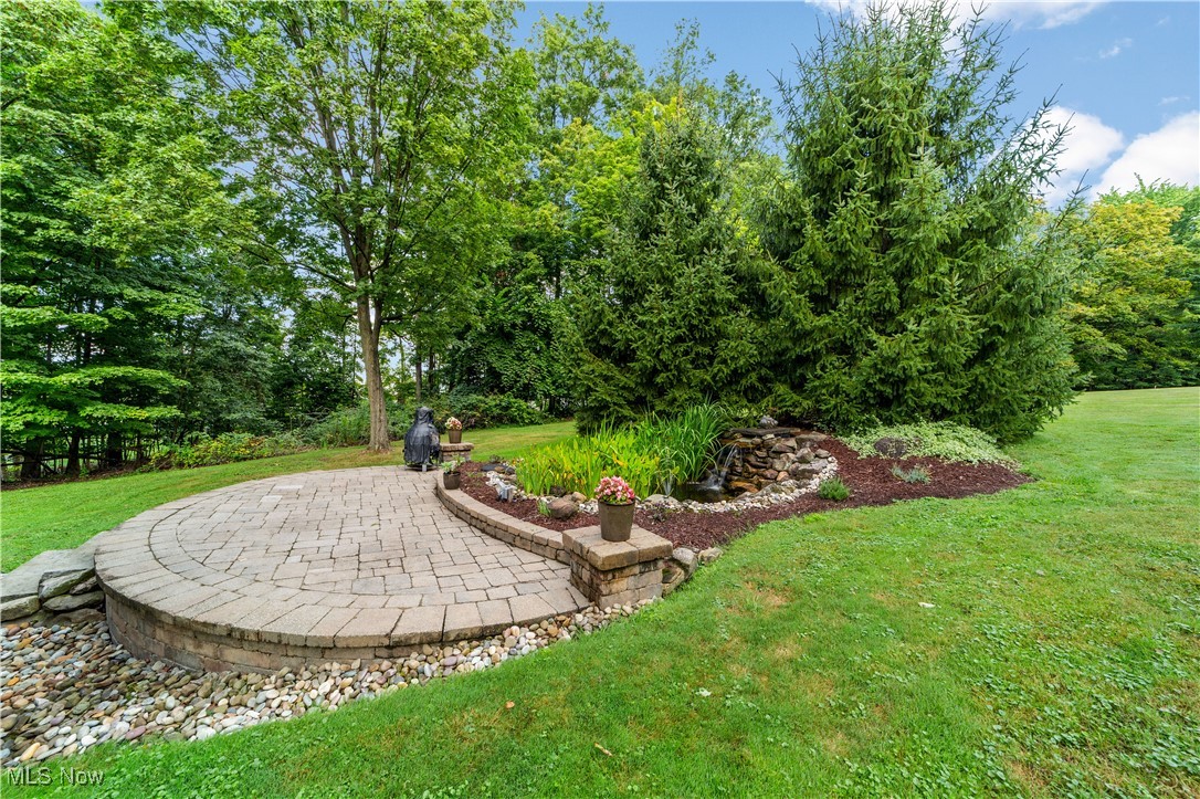30825 Cannon Road Solon, OH 44139 - Photo 41 of 49 View of green lawn with a patio and view of wooded area