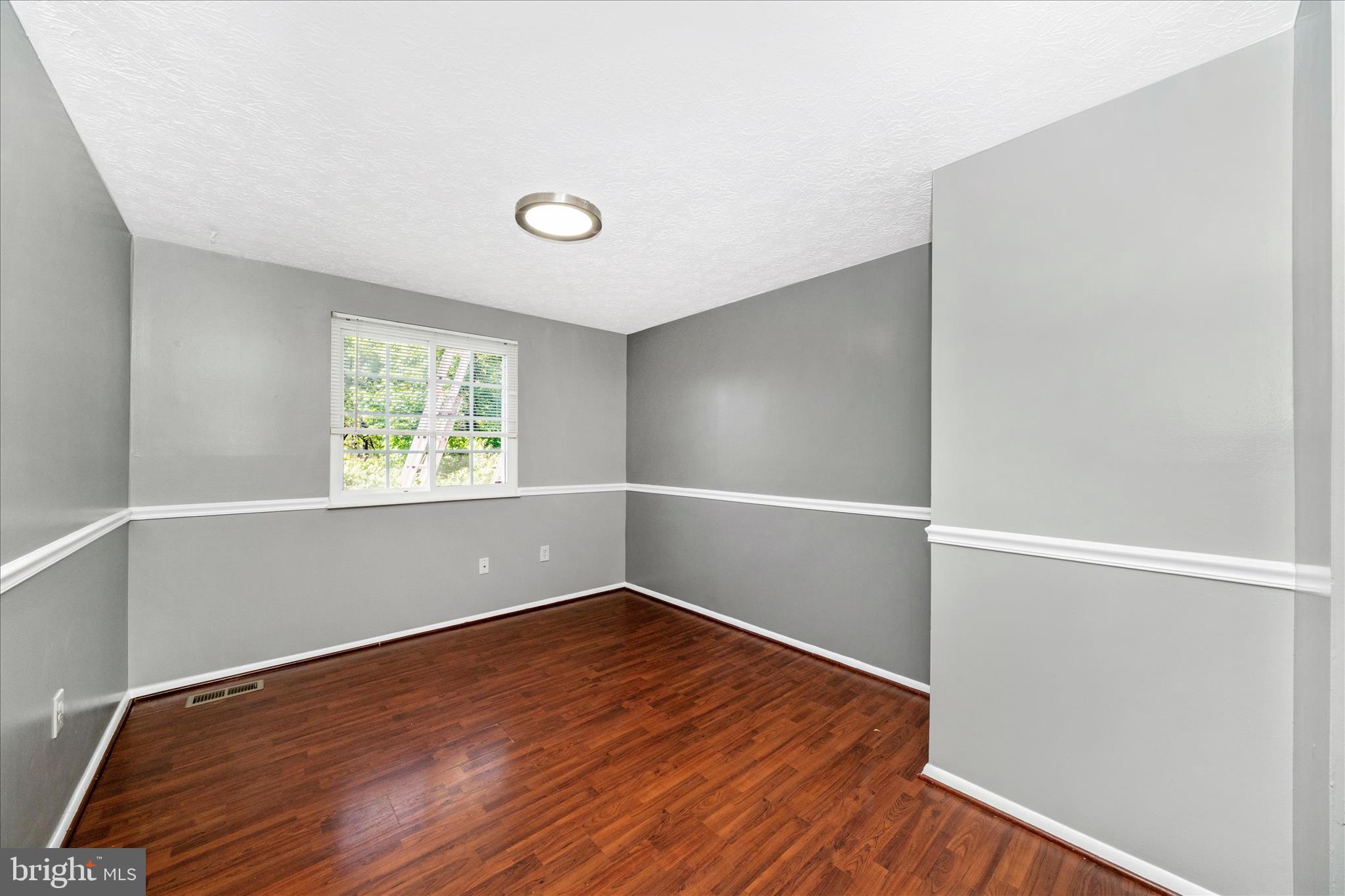 3749 Castle Terrace, Unit 12114 Silver Spring, MD 20904 - Photo 8 of 51 an empty room with wooden floor and windows