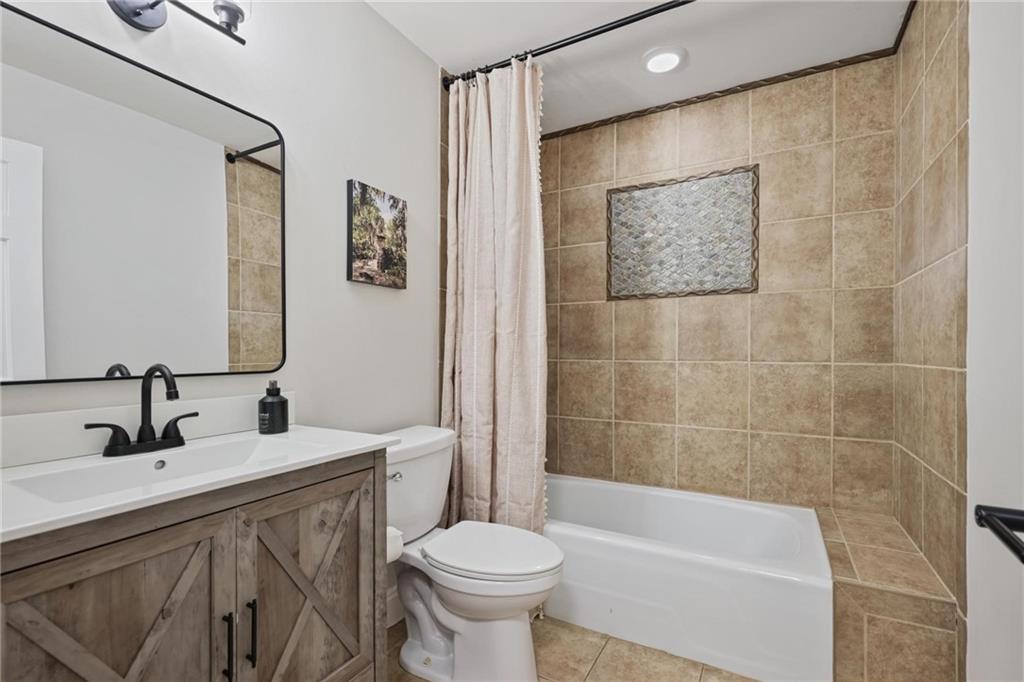 7680 Ryefield Drive Atlanta, GA 30350 - Photo 14 of 49 a bathroom with a sink a toilet and shower