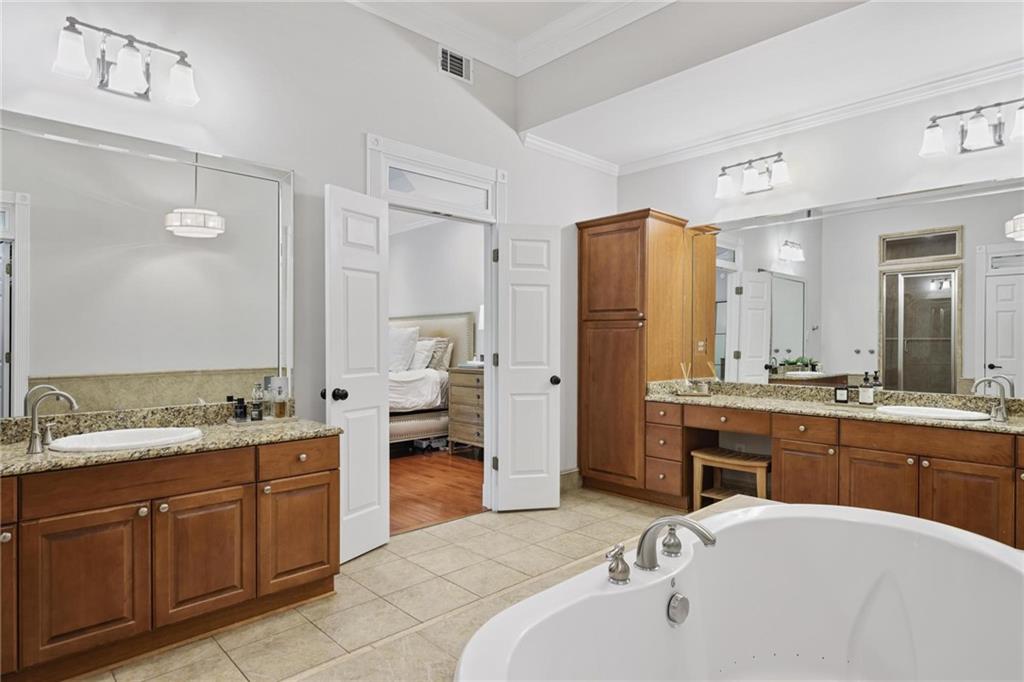 7680 Ryefield Drive Atlanta, GA 30350 - Photo 19 of 49 a spacious bathroom with a tub sink and mirror