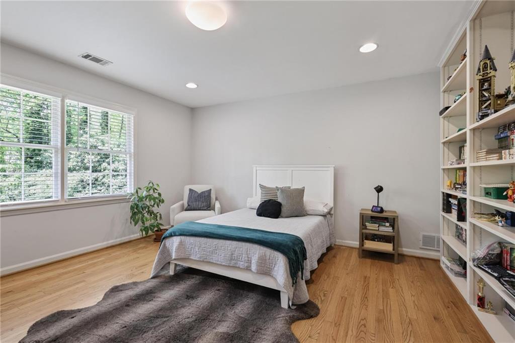 7680 Ryefield Drive Atlanta, GA 30350 - Photo 21 of 49 a bedroom with a bed and a book shelf