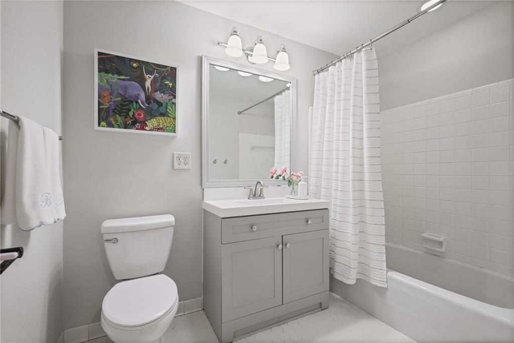 7680 Ryefield Drive Atlanta, GA 30350 - Photo 25 of 49 a bathroom with a toilet sink and mirror
