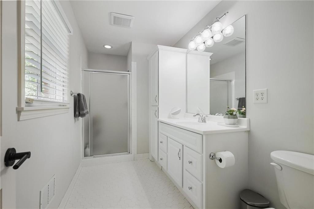 7680 Ryefield Drive Atlanta, GA 30350 - Photo 27 of 49 a bathroom with a double vanity sink toilet and mirror