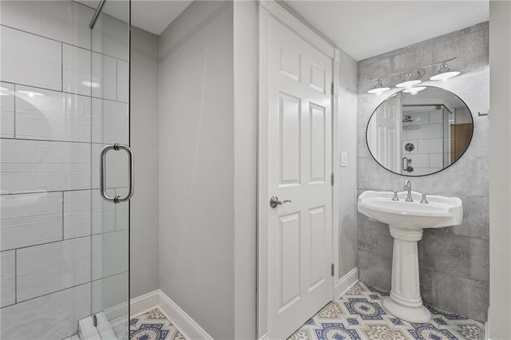 7680 Ryefield Drive Atlanta, GA 30350 - Photo 31 of 49 a bathroom with a sink a toilet and shower