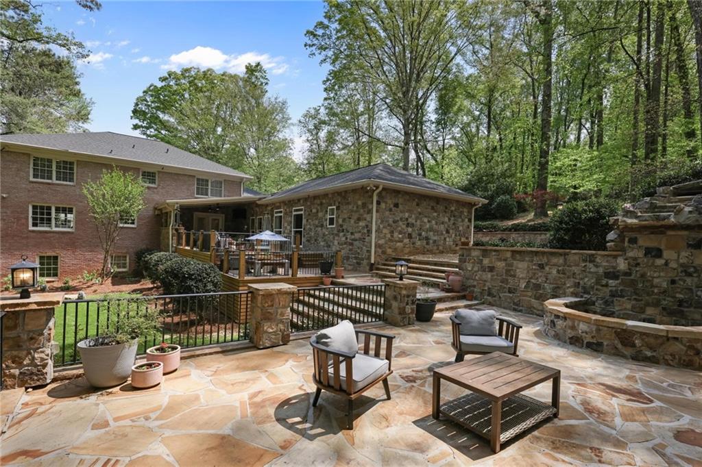 7680 Ryefield Drive Atlanta, GA 30350 - Photo 36 of 49 a view of a chairs and tables in the back yard of the house