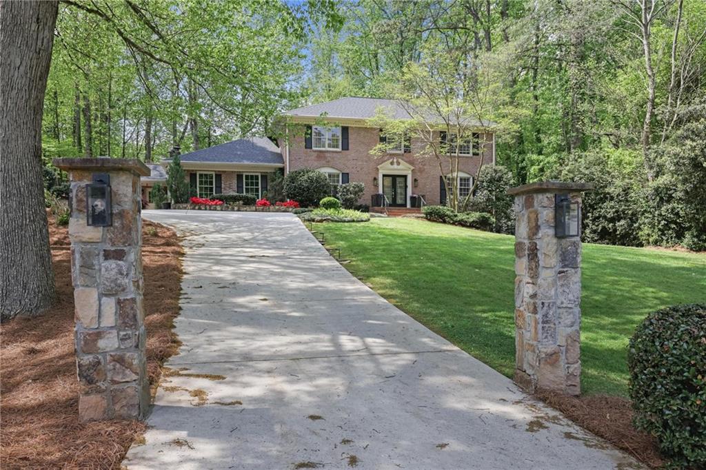 7680 Ryefield Drive Atlanta, GA 30350 - Photo 46 of 49 a view of a patio with a table and chairs under an umbrella