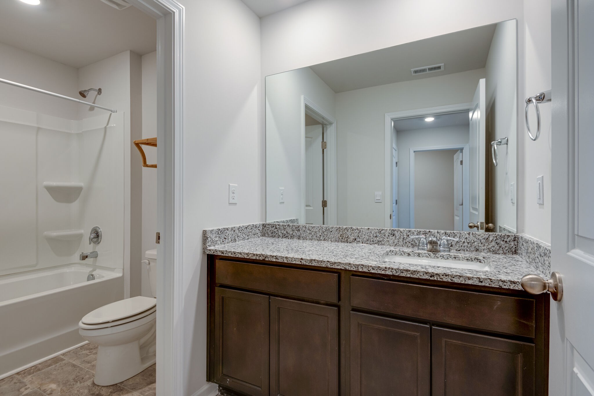 7708 Stapleton Chase Drive Antioch, TN 37013 - Photo 18 of 22 a bathroom with a granite countertop sink toilet a shower and a mirror
