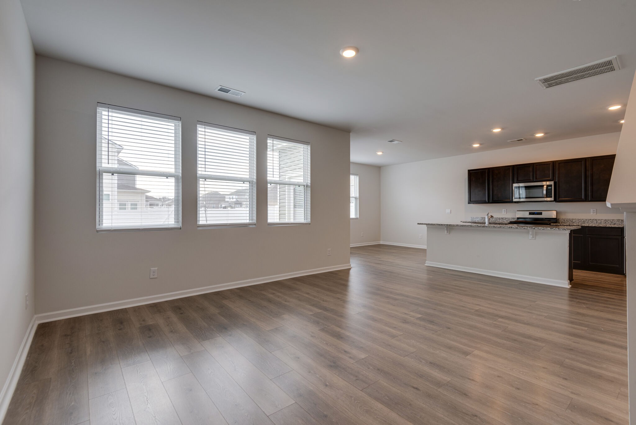 7708 Stapleton Chase Drive Antioch, TN 37013 - Photo 6 of 22 a view of an empty room with wooden floor and a window