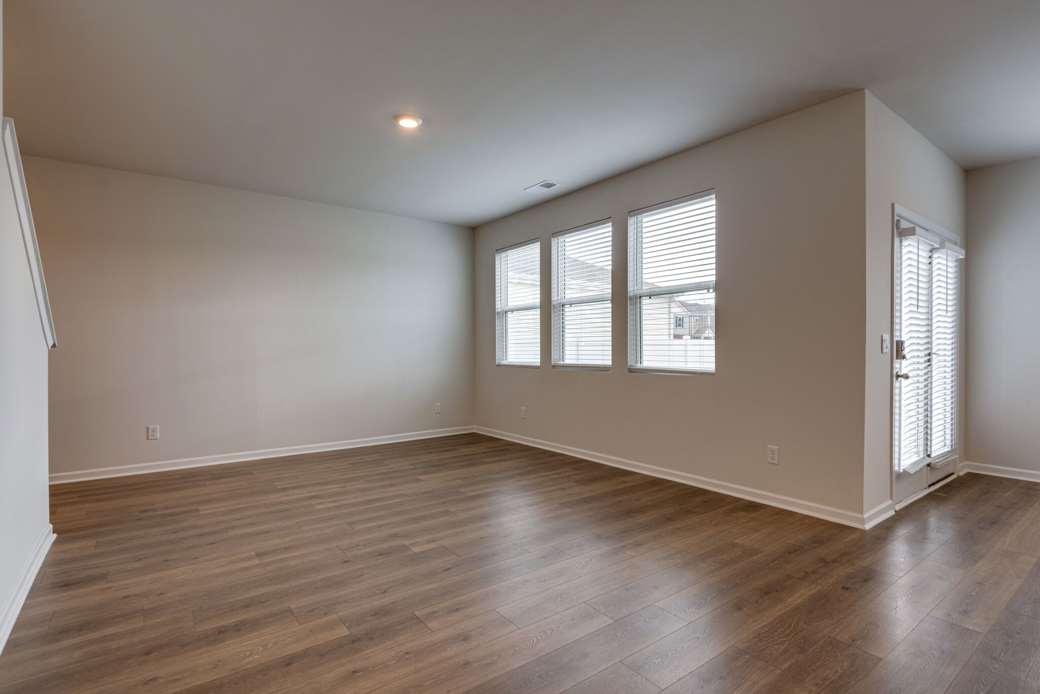 7708 Stapleton Chase Drive Antioch, TN 37013 - Photo 8 of 22 a view of an empty room with wooden floor and a window