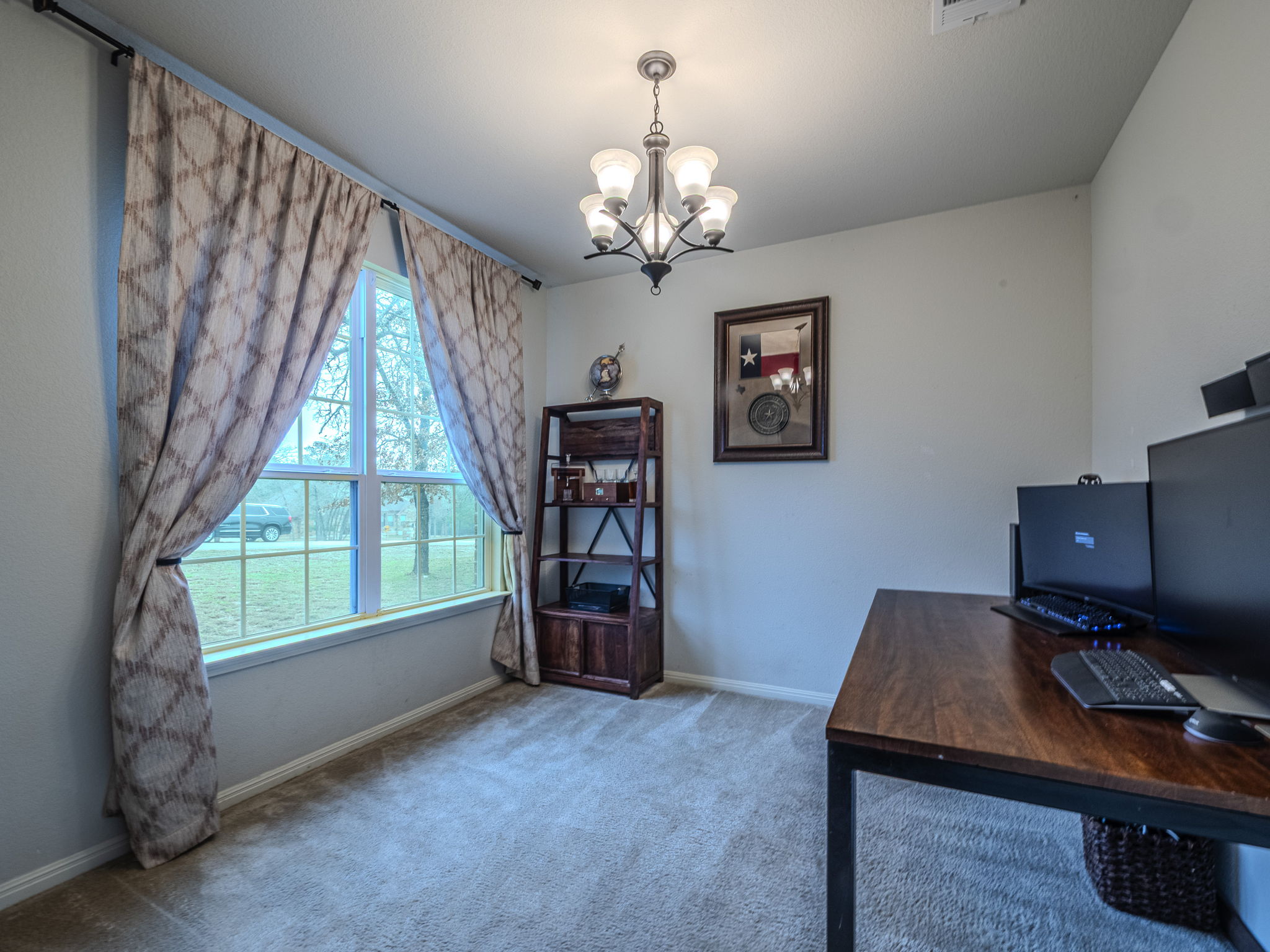 117 Arbor Point Drive Elgin, TX 78621 - Photo 19 of 40 Home office featuring hanging lights and carpet floors