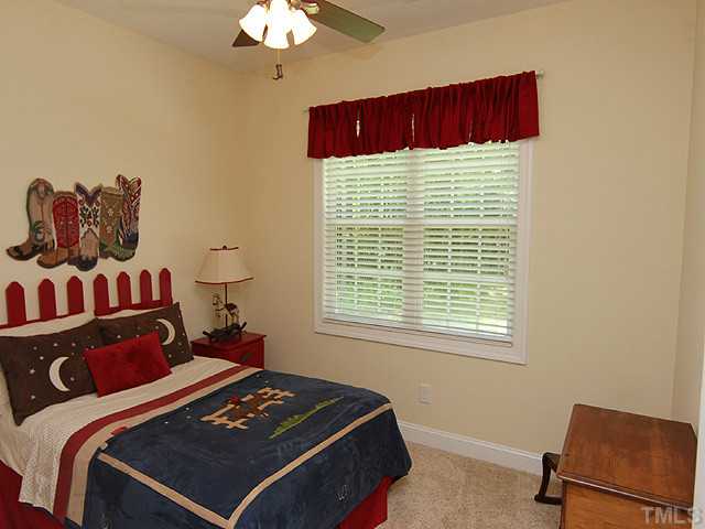 262 Ned Moore Road Timberlake, NC 27583 - Photo 10 of 12 a bedroom with a bed and a window