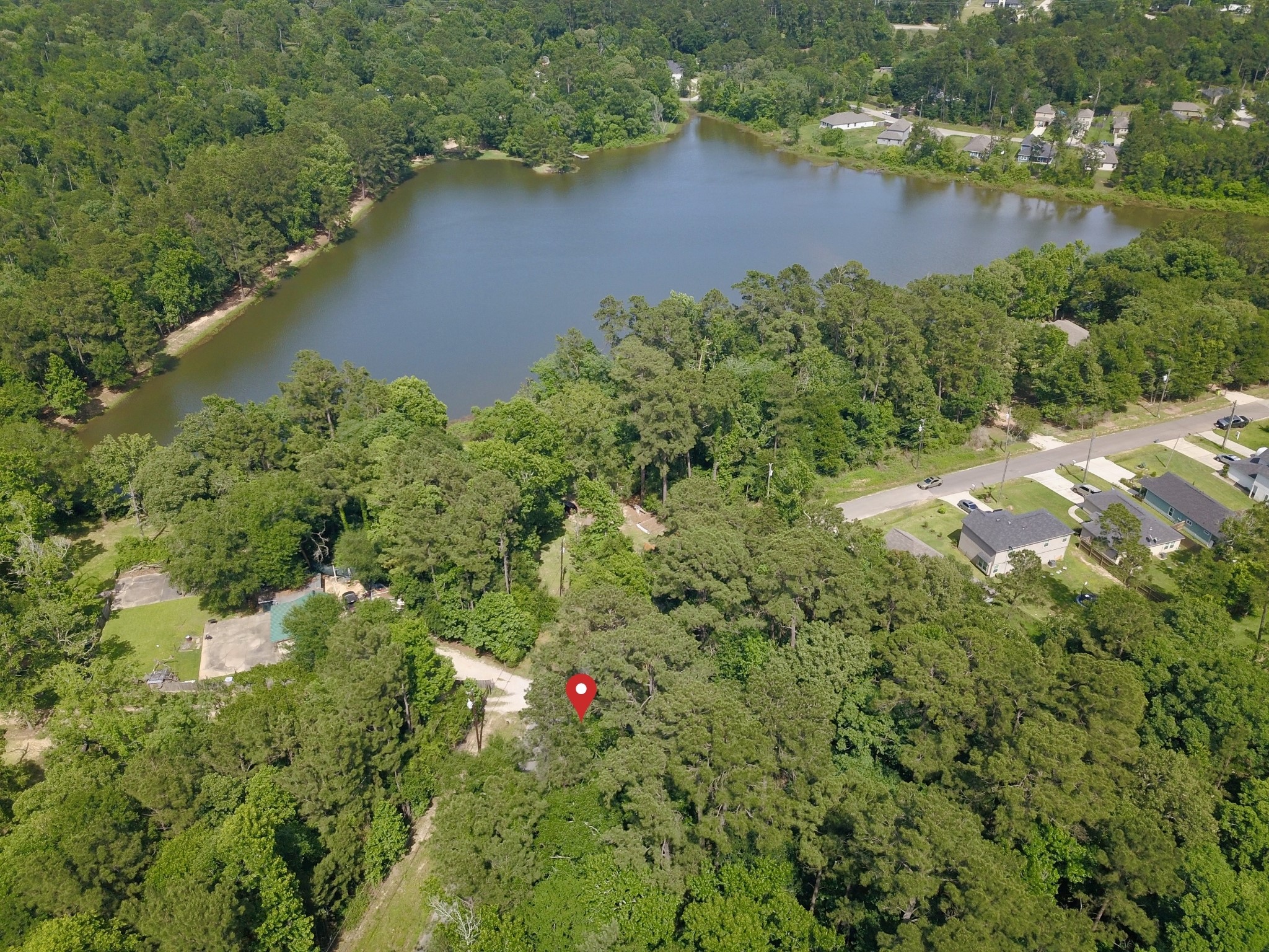 Tbd Crockett Road Willis, TX 77378 - Photo 2 of 13 an aerial view of lake residential house with outdoor space and trees around