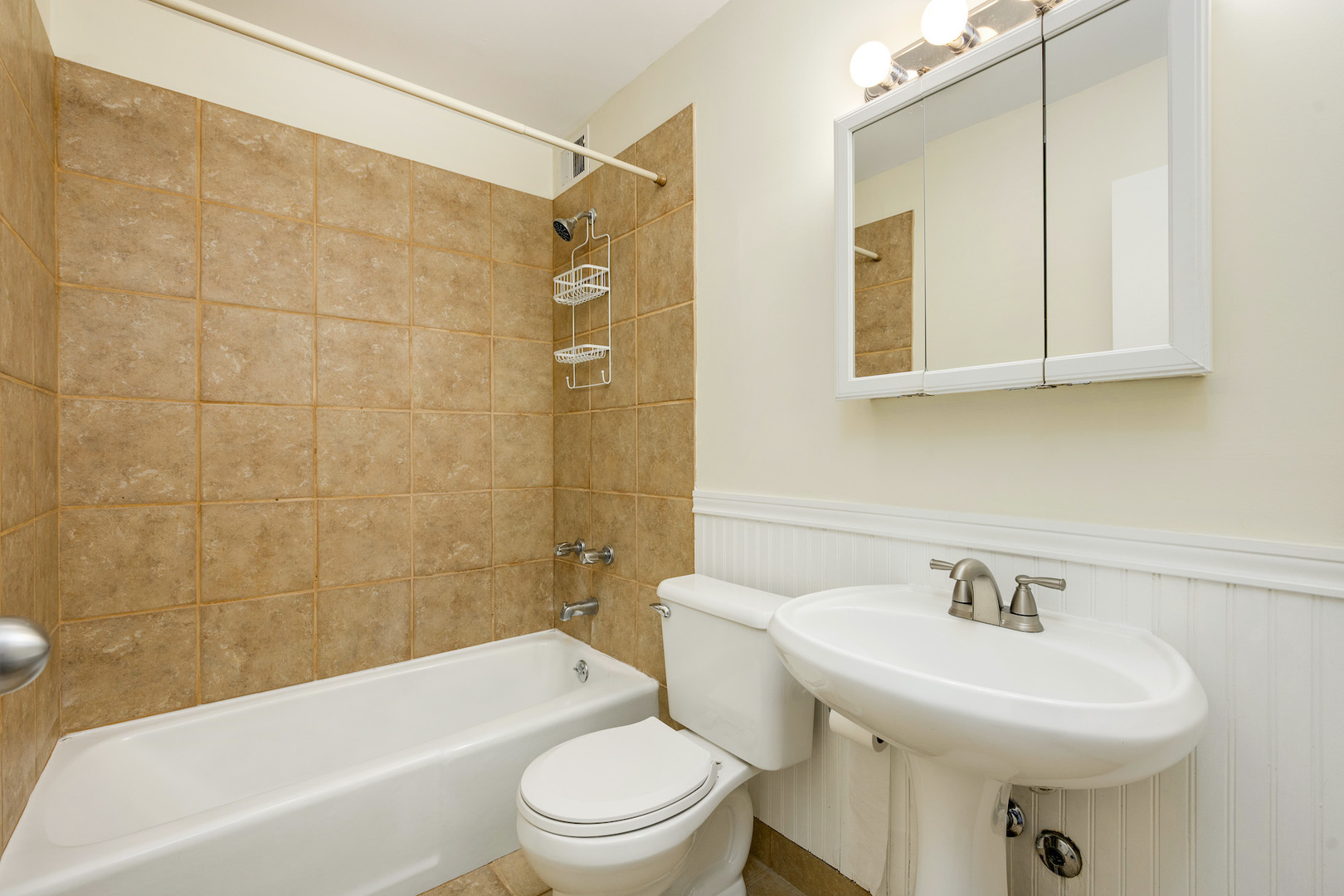 5415 North Sheridan Road, Unit 412 Chicago, IL 60640 - Photo 11 of 22 a bathroom with a sink a toilet and shower
