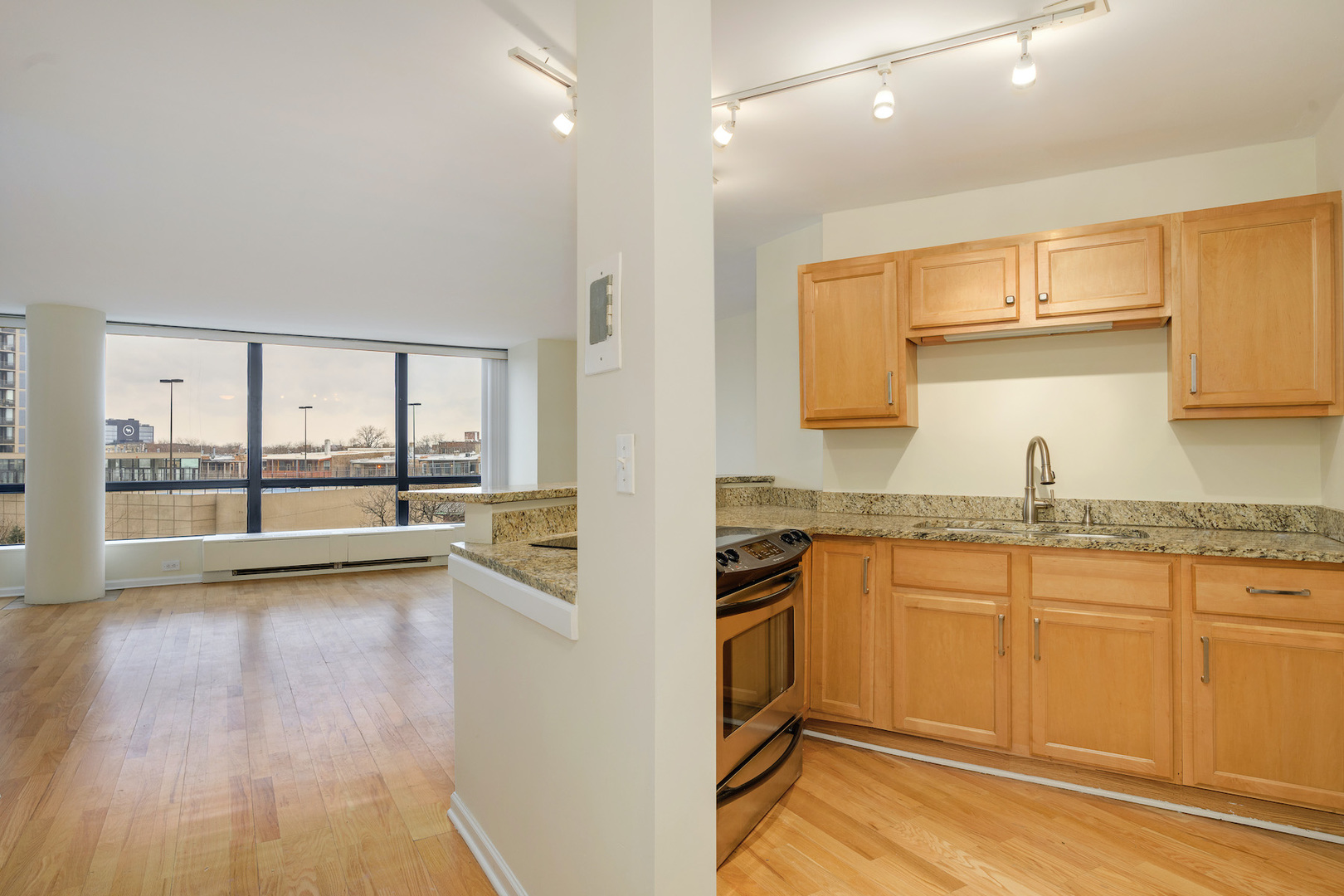 5415 North Sheridan Road, Unit 412 Chicago, IL 60640 - Photo 4 of 22 a view of a kitchen with a sink and wooden floor