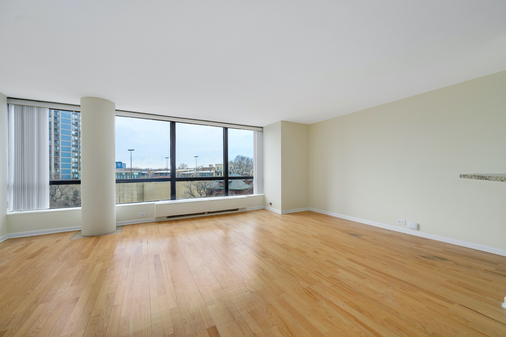 5415 North Sheridan Road, Unit 412 Chicago, IL 60640 - Photo 5 of 22 wooden floor in an empty room with a window