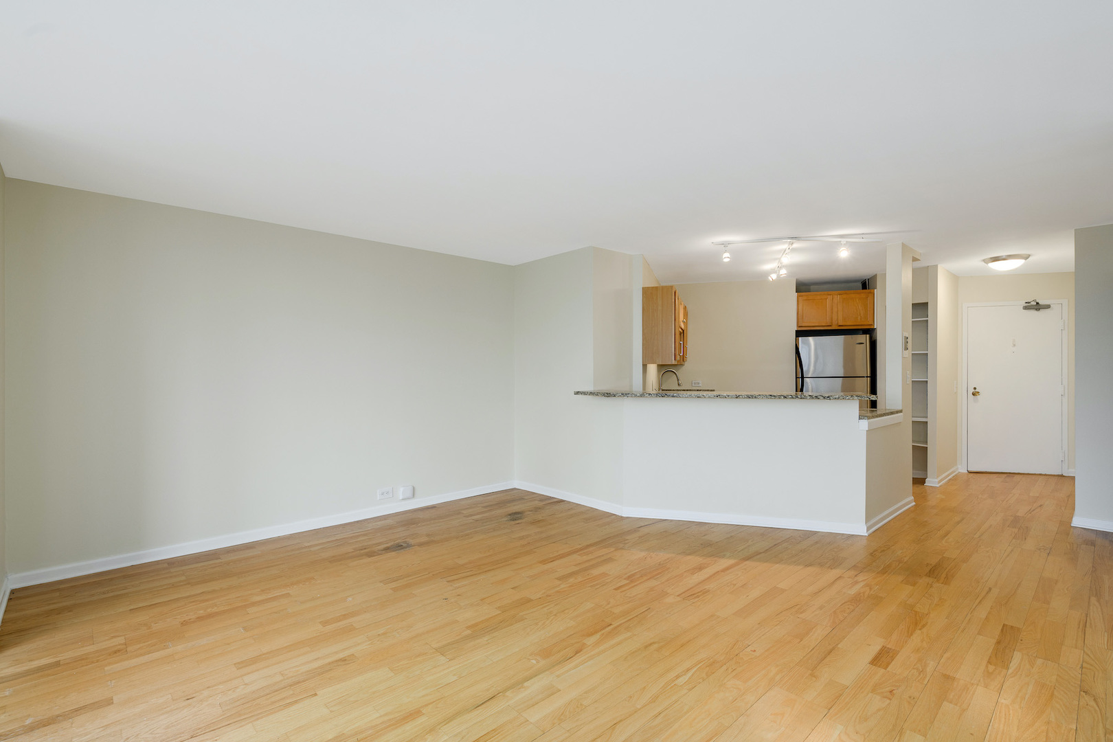 5415 North Sheridan Road, Unit 412 Chicago, IL 60640 - Photo 7 of 22 a view of a kitchen with a sink and a mirror