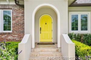 4865 Southeast Manatee Cove Road Stuart, FL 34997 - Photo 1 of 53 a view of a brick house with a small entryway