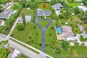 4865 Southeast Manatee Cove Road Stuart, FL 34997 - Photo 11 of 53 an aerial view of a pool
