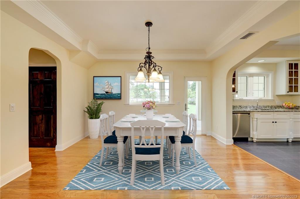 4865 Southeast Manatee Cove Road Stuart, FL 34997 - Photo 13 of 53 a view of a dining room with furniture window and wooden floor