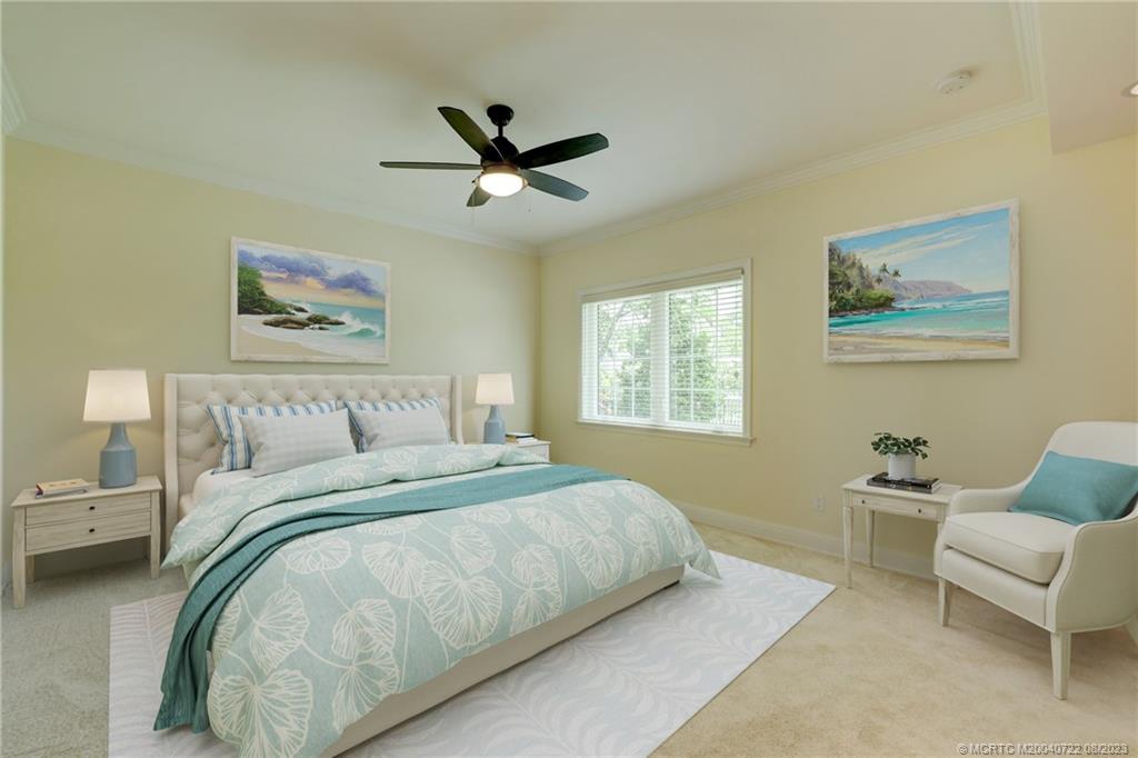 4865 Southeast Manatee Cove Road Stuart, FL 34997 - Photo 14 of 53 a bedroom with a bed and furniture
