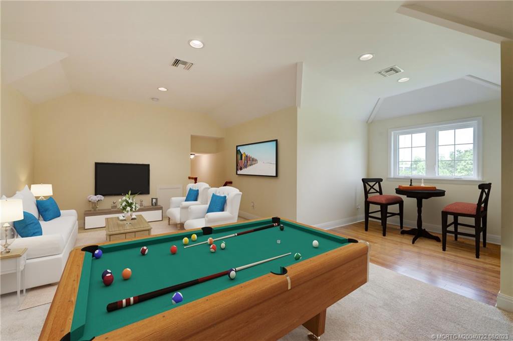 4865 Southeast Manatee Cove Road Stuart, FL 34997 - Photo 15 of 53 a living room with furniture and a flat screen tv