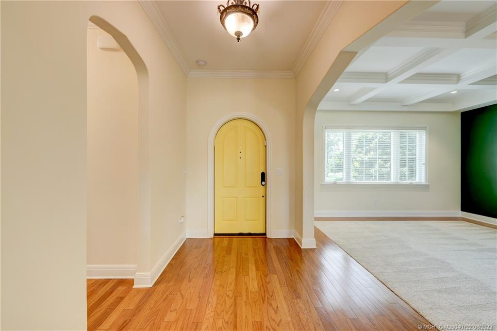 4865 Southeast Manatee Cove Road Stuart, FL 34997 - Photo 18 of 53 an empty room with wooden floor and windows