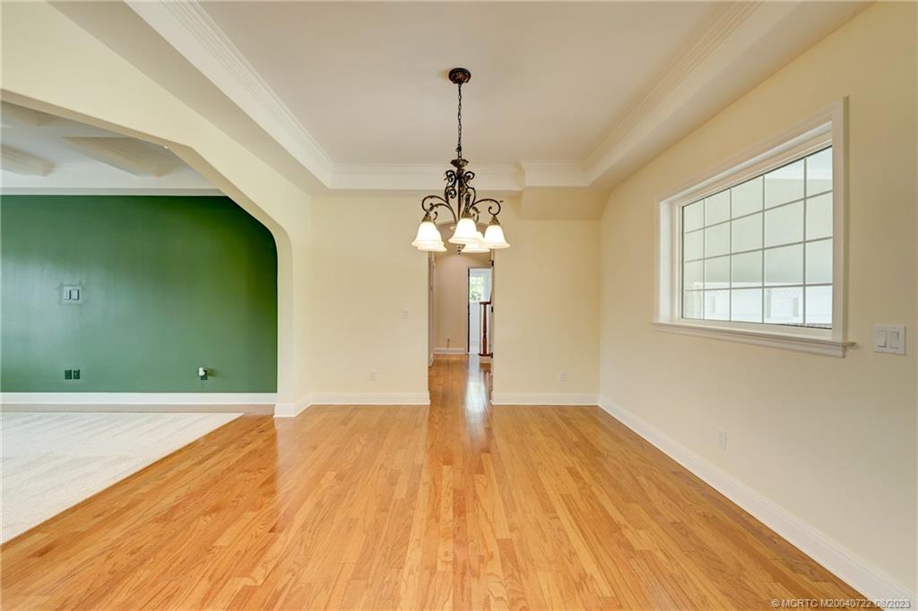 4865 Southeast Manatee Cove Road Stuart, FL 34997 - Photo 21 of 53 a view of a room with wooden floor staircase and a kitchen