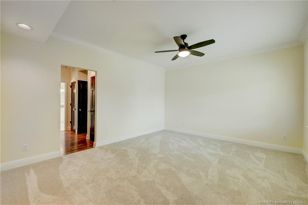 4865 Southeast Manatee Cove Road Stuart, FL 34997 - Photo 29 of 53 an empty room with a ceiling fan and window