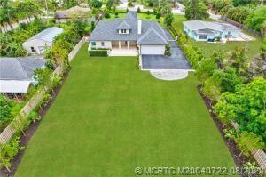 4865 Southeast Manatee Cove Road Stuart, FL 34997 - Photo 3 of 53 an aerial view of a house