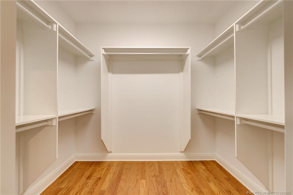 4865 Southeast Manatee Cove Road Stuart, FL 34997 - Photo 31 of 53 a view of walk in closet with wooden floor