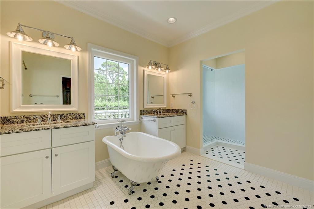 4865 Southeast Manatee Cove Road Stuart, FL 34997 - Photo 33 of 53 a bathroom with a sink toilet a mirror and shower