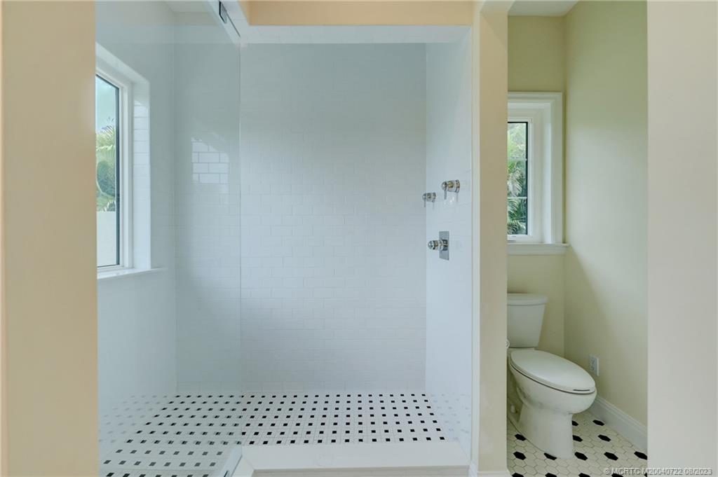 4865 Southeast Manatee Cove Road Stuart, FL 34997 - Photo 34 of 53 a bathroom with a toilet and a shower