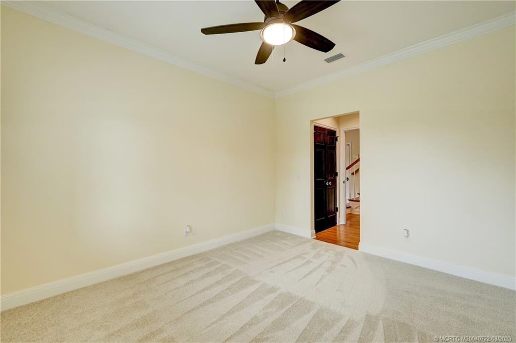 4865 Southeast Manatee Cove Road Stuart, FL 34997 - Photo 36 of 53 an empty room with closet and fan