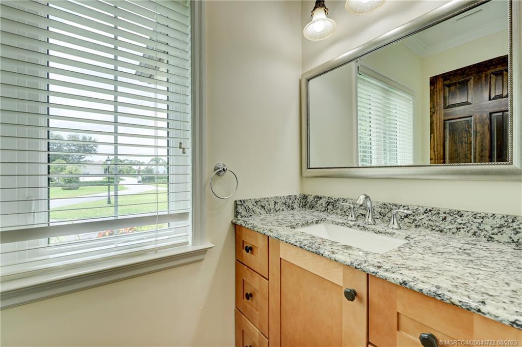 4865 Southeast Manatee Cove Road Stuart, FL 34997 - Photo 37 of 53 a bathroom with a granite countertop sink and a window