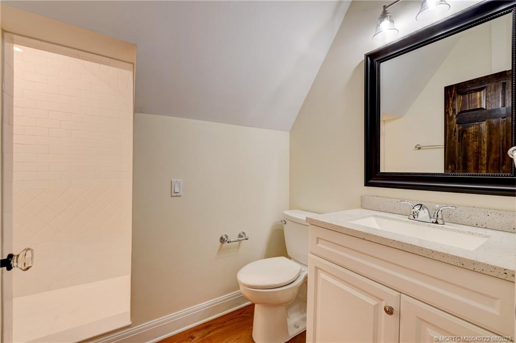4865 Southeast Manatee Cove Road Stuart, FL 34997 - Photo 44 of 53 a bathroom with a toilet sink and mirror