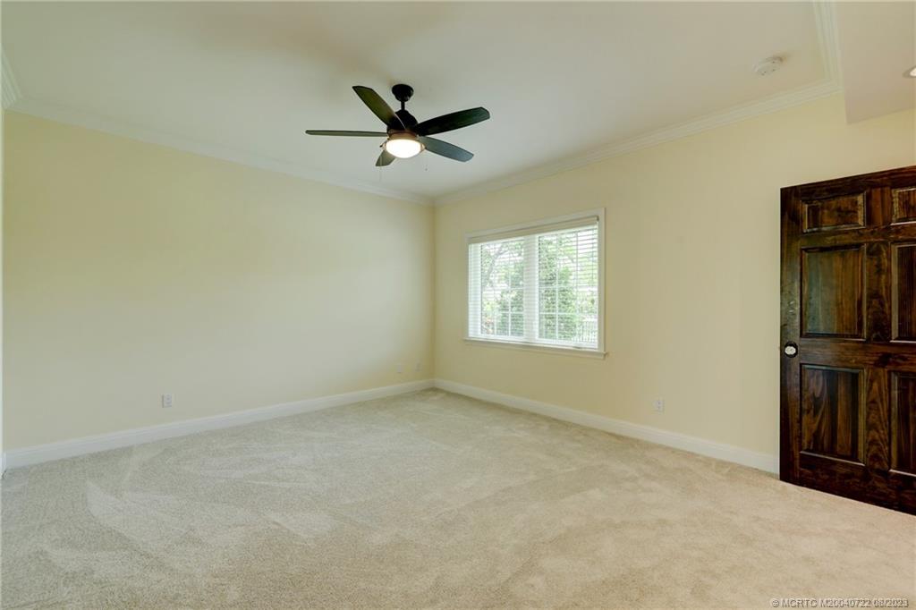 4865 Southeast Manatee Cove Road Stuart, FL 34997 - Photo 46 of 53 an empty room with closet area and fan