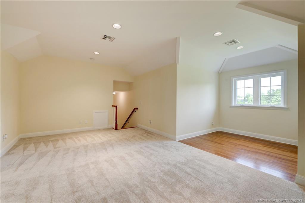 4865 Southeast Manatee Cove Road Stuart, FL 34997 - Photo 48 of 53 wooden floor in an empty room with a window