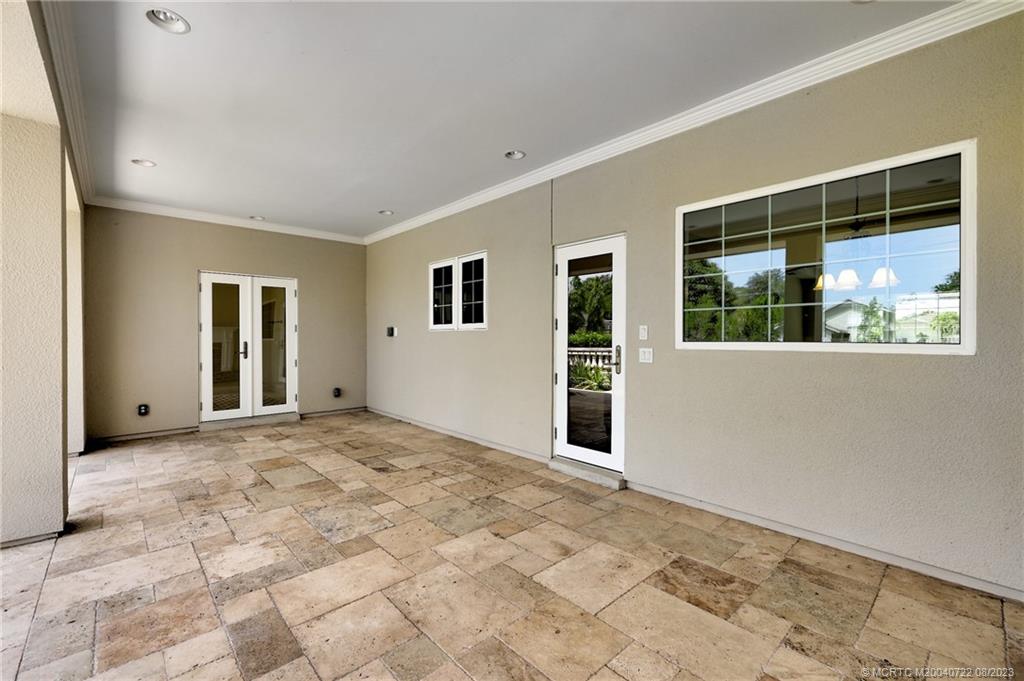4865 Southeast Manatee Cove Road Stuart, FL 34997 - Photo 49 of 53 a view of an empty room with window and wooden floor